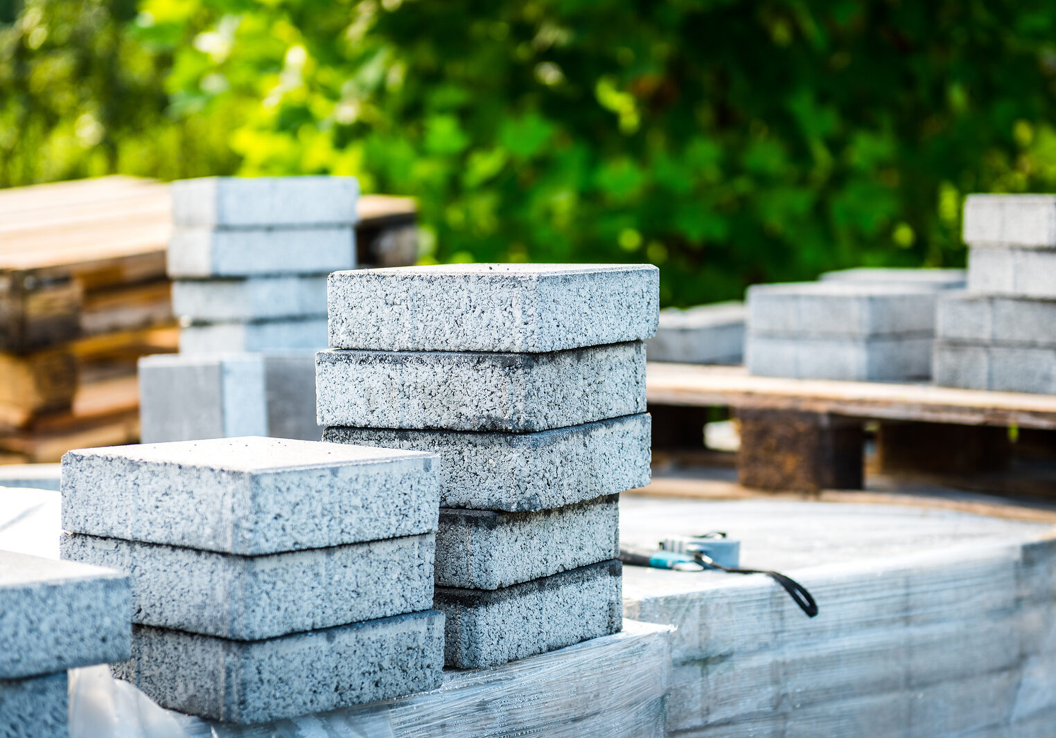 Stack Of Concrete Paving Slabs Tiles Ready For Laying Pavement. Mason Sand